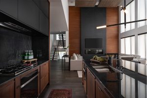 open concept black and wood kitchen and living room
