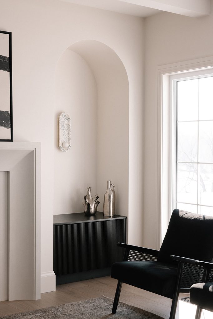 Black reeded cabinet inside archway