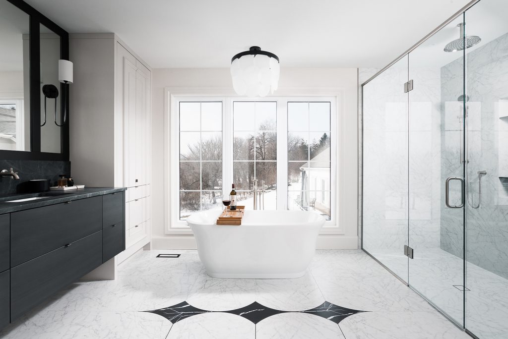 Primary ensuite with custom vanity and intricate floor detail