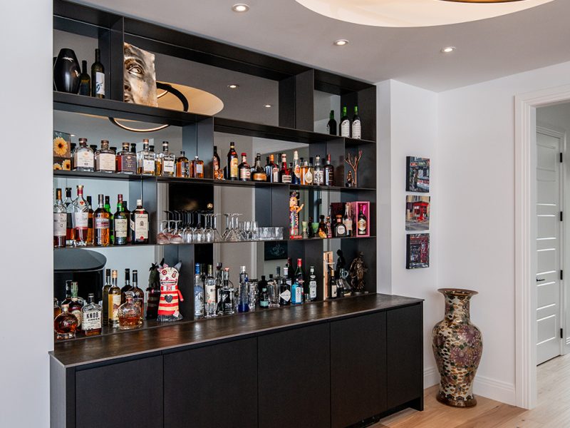 Black bar cabinets with open liquor storage