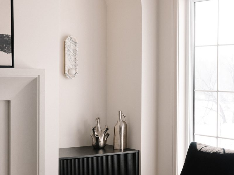 Black reeded cabinet inside archway