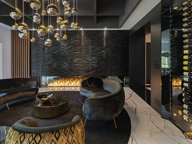 Black feature wall in living room with fluted wood accent