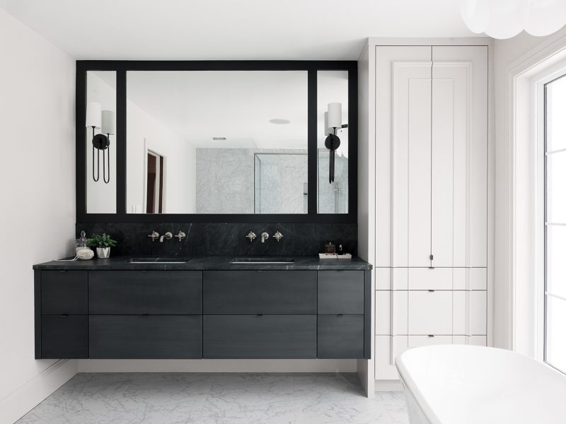 Custom dark vanity with white linen cabinet