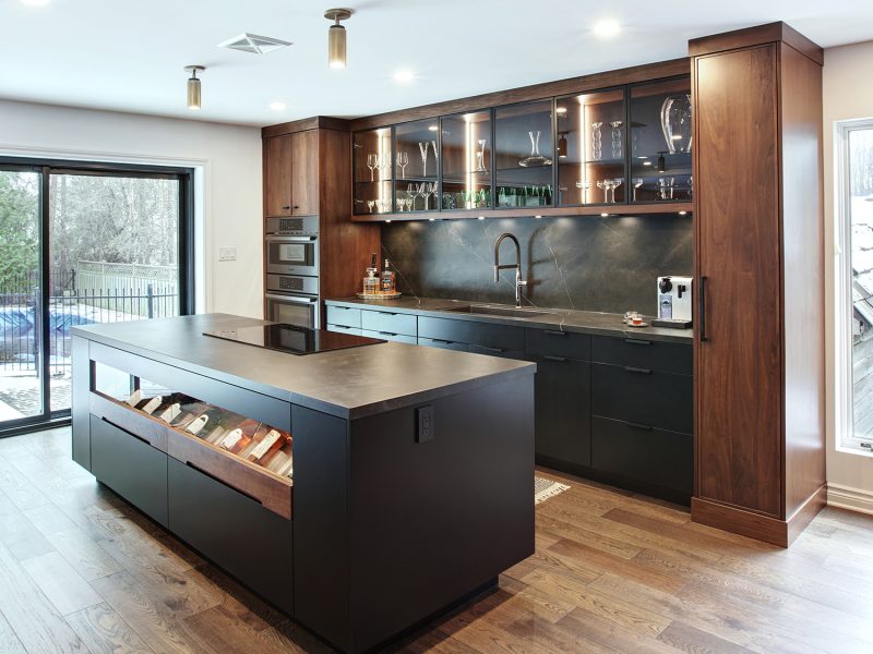 Black and walnut kitchen with wine storage inside island
