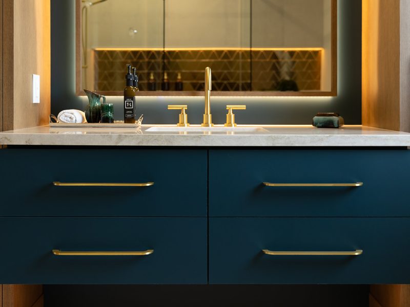 Blue green vanity with gold hardware