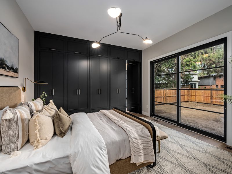 Primary bedroom with black closet cabinets