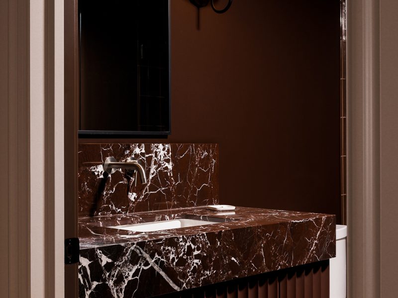 Colour drenched powder room with fluted vanity