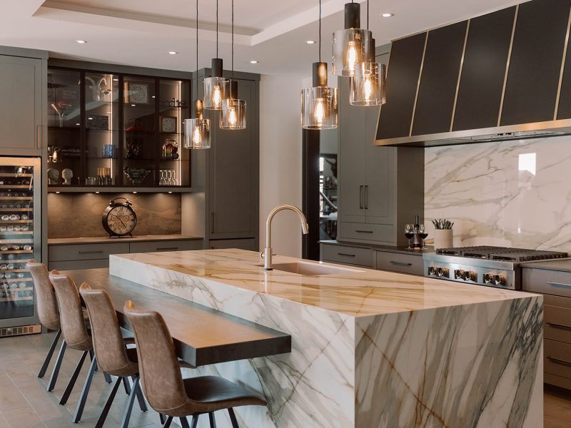 Contemporary grey kitchen cabinets with black range hood