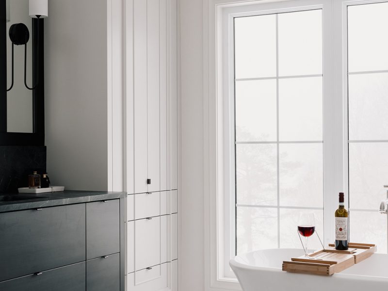 Tall white linen cabinet with custom door