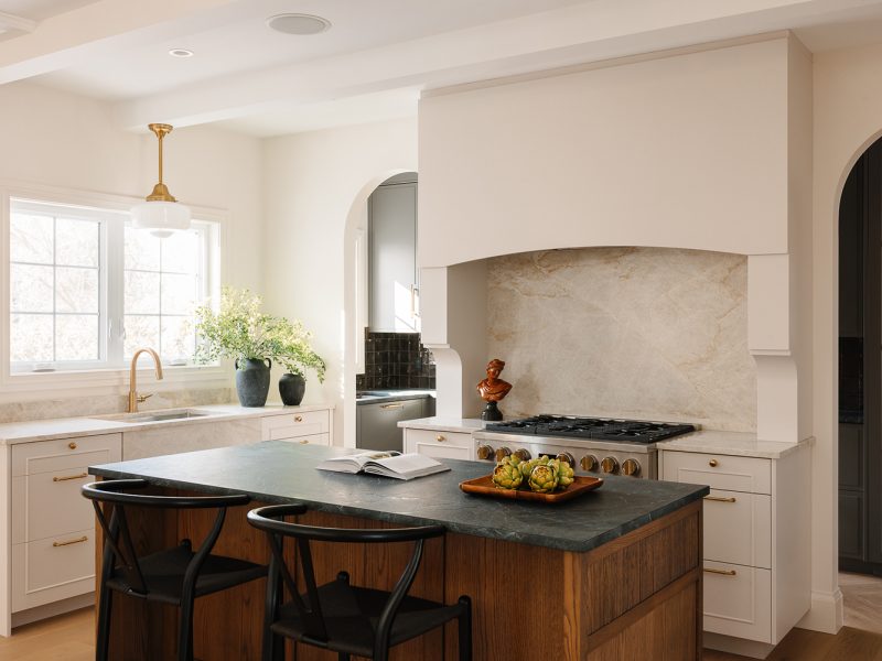 Stained island with oversized range hood