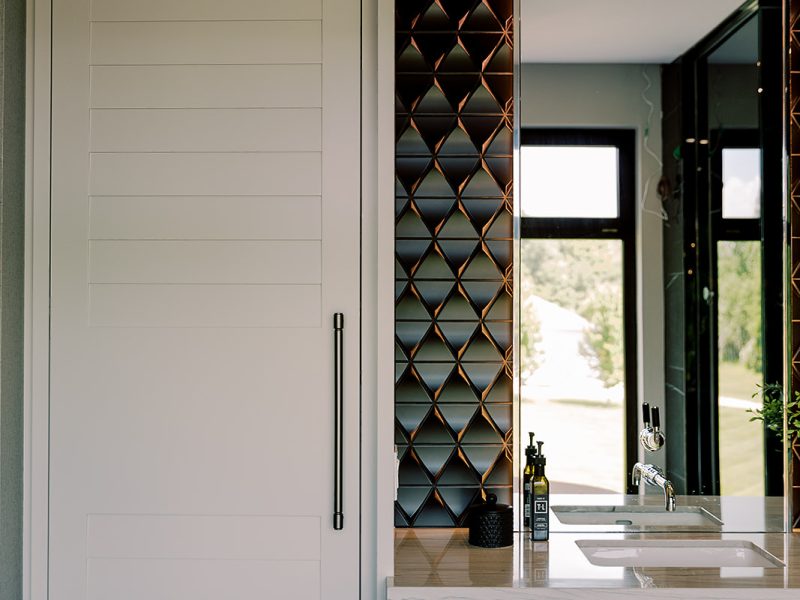 Custom white linen cabinet beside floating vanity