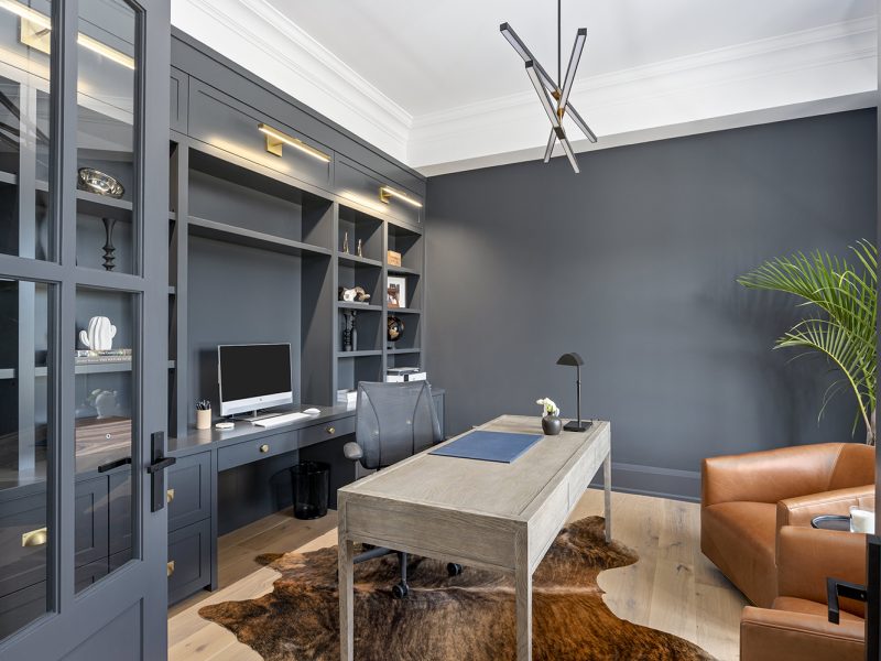 Dark home office with gold library lights