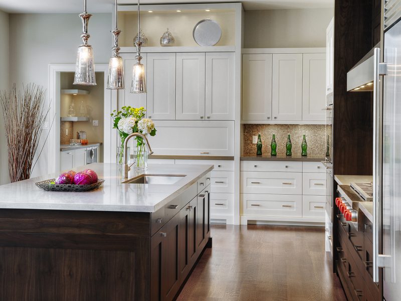 Dark kitchen island with white wall cabinets