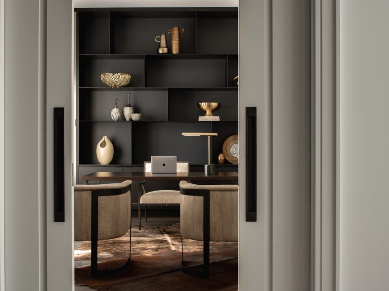 Home office with floor to ceiling shelf