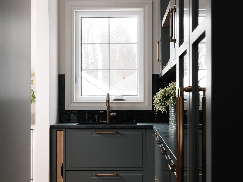 Black painted pantry with cutting board storage
