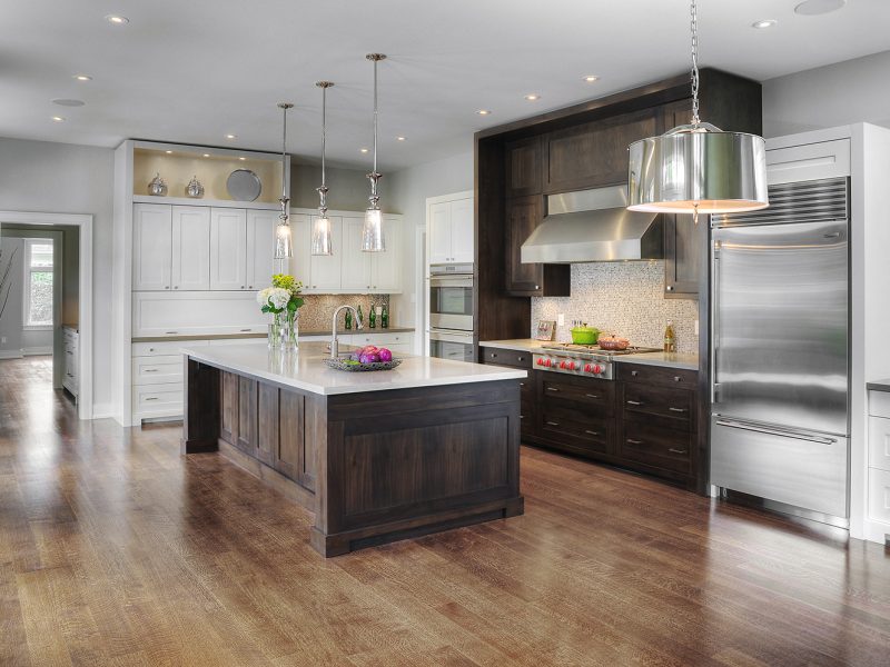 Dark stained cabinets with white painted cabinets in kitchen