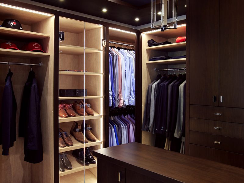 Dark walk-in closet with men's dedicated storage