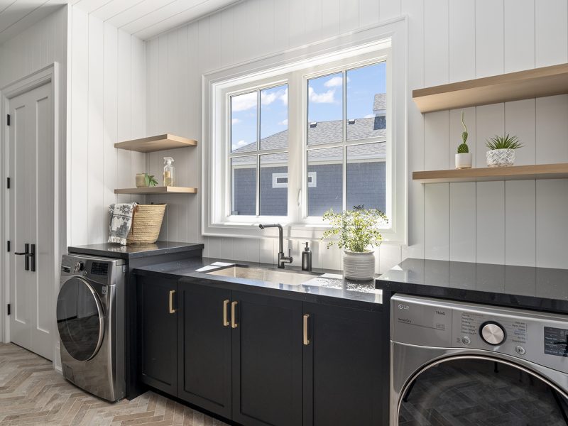 Laundry sink cabinets with shiplap walls