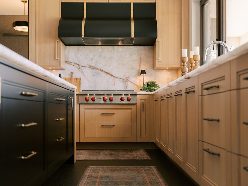 Light oak cabinets with black painted kitchen island