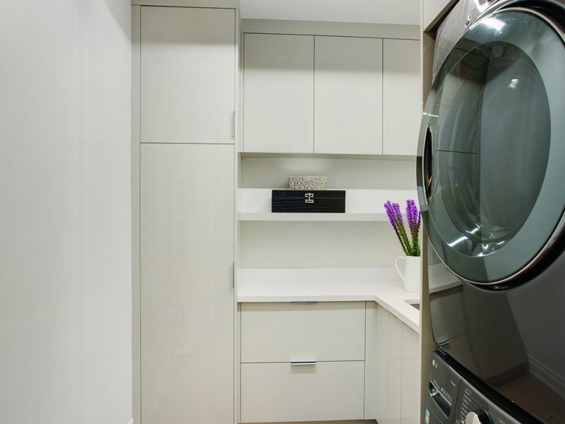 Minimalist white laundry cabinets