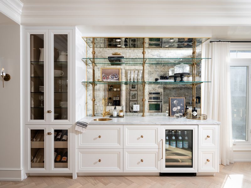 Bar cabinet with gold open shelves and antique mirror backsplash