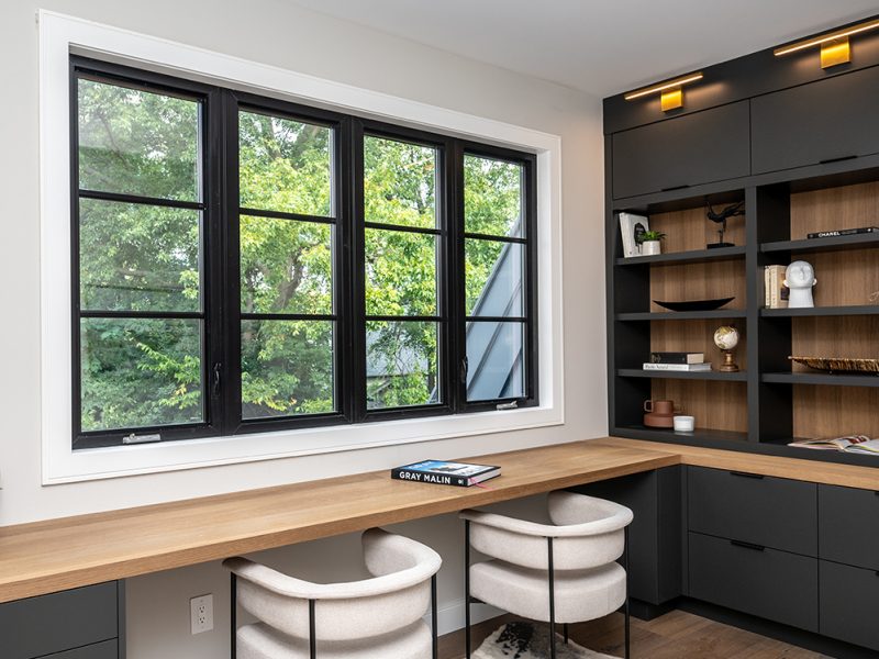 Home office with shelves and attached desk