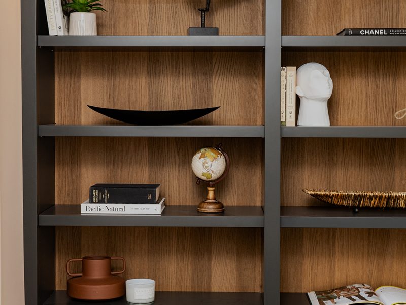 Black painted cabinets with dark wood interior for home office