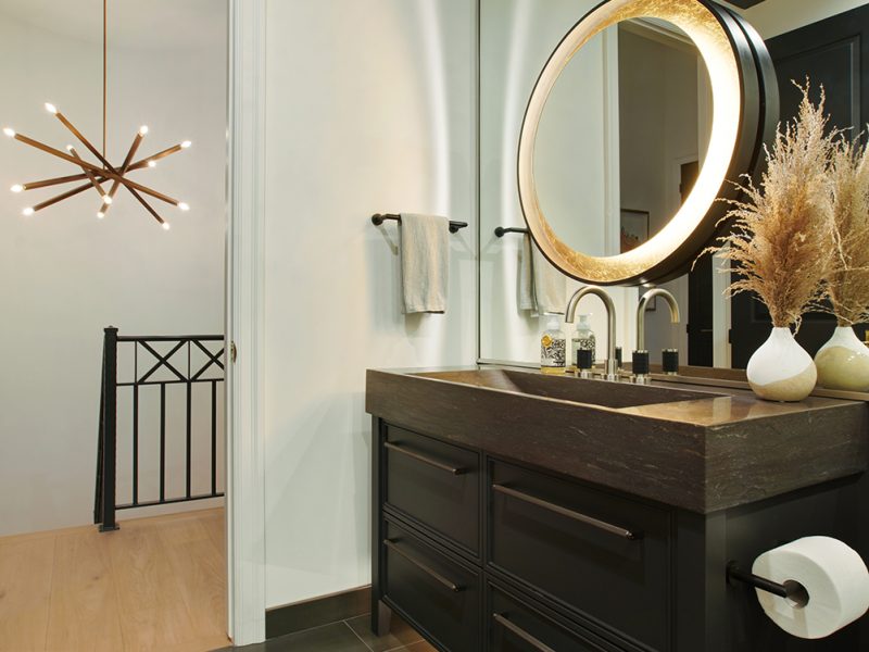 Powder room table style vanity with circular mirror