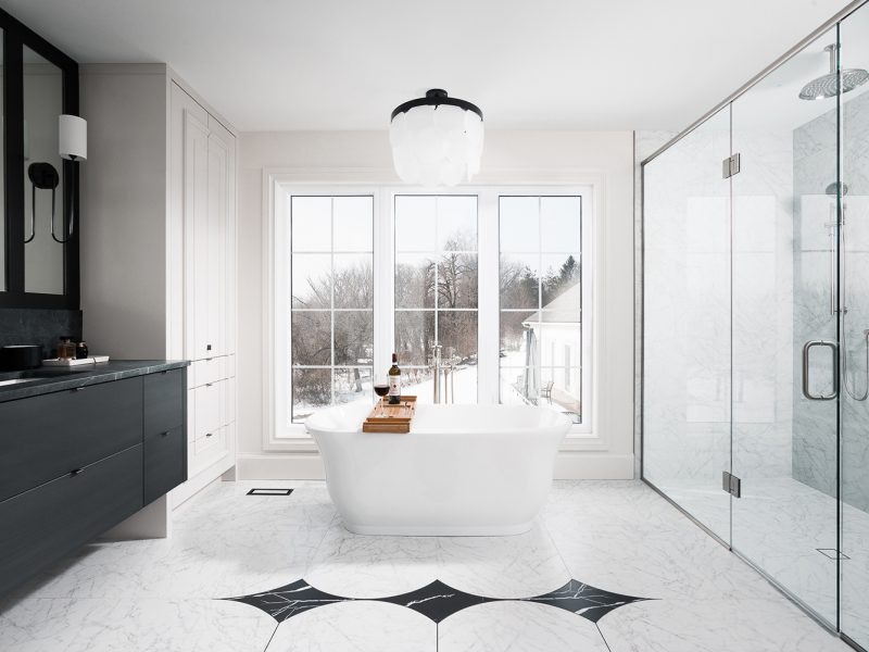 Primary ensuite with custom vanity and intricate floor detail
