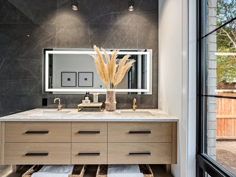 Light oak primary ensuite vanity with matte black hardware