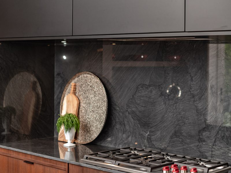 Walnut cabinets with black range hood