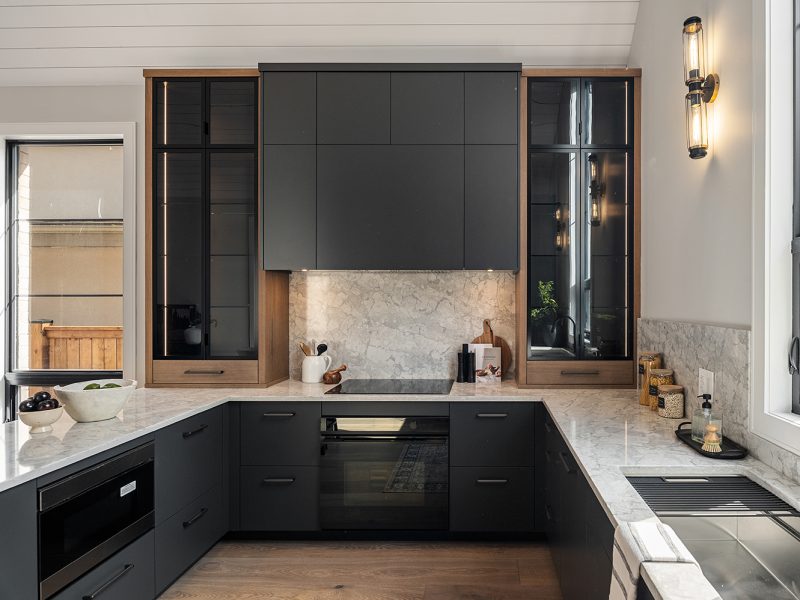 Shaded glass display cabinets on either side of range oven