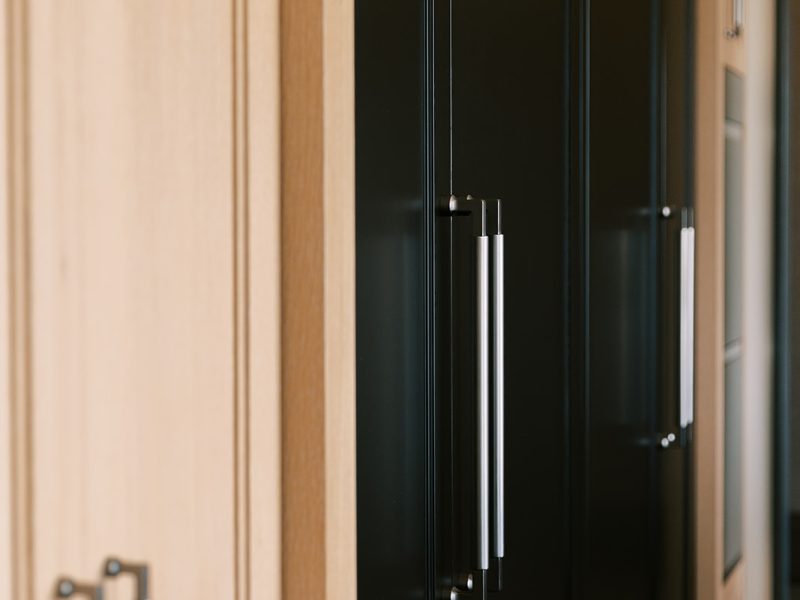 Stained white oak cabinets with contrasting black painted cabinets