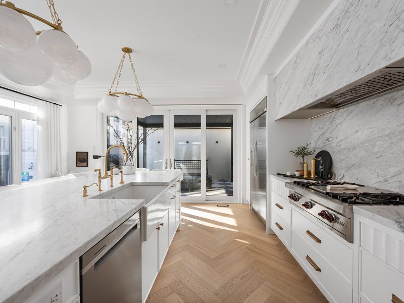 White custom cabinets with gold hardware