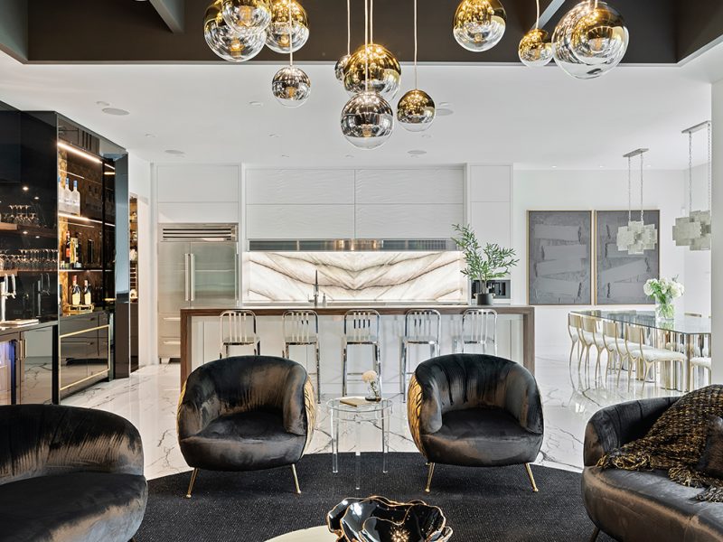 Open concept white kitchen with black living room