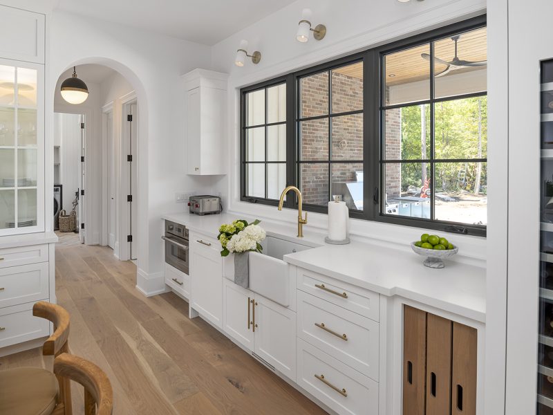 White kitchen cabinets with window behind