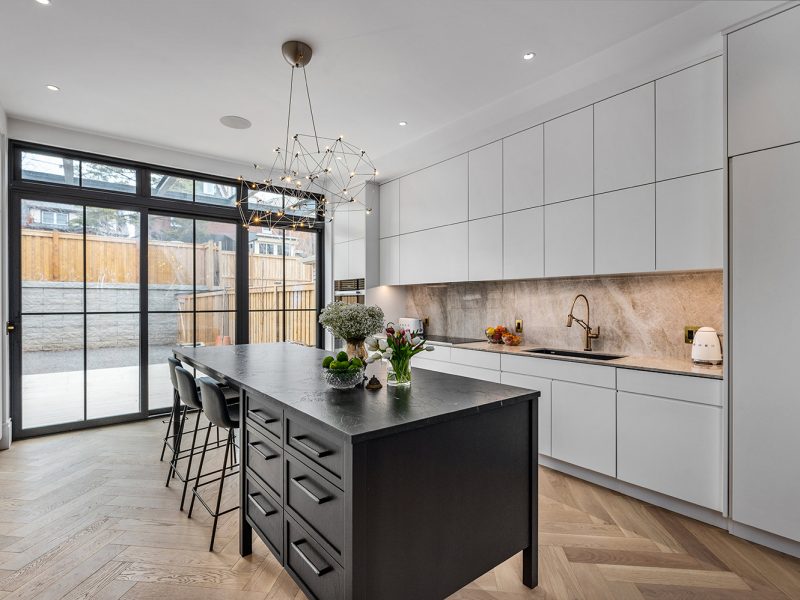 Off white kitchen with dark island