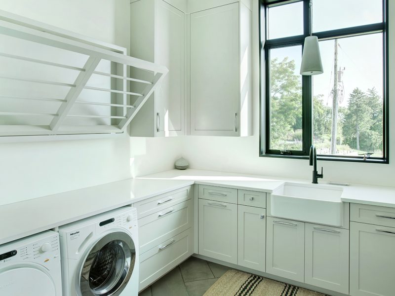 White laundry room with drying rack