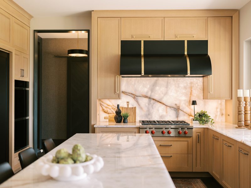 light wood kitchen with dark range hood